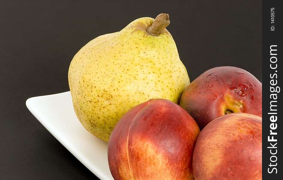 Pear and Nectarines on plain background, Studio shot.