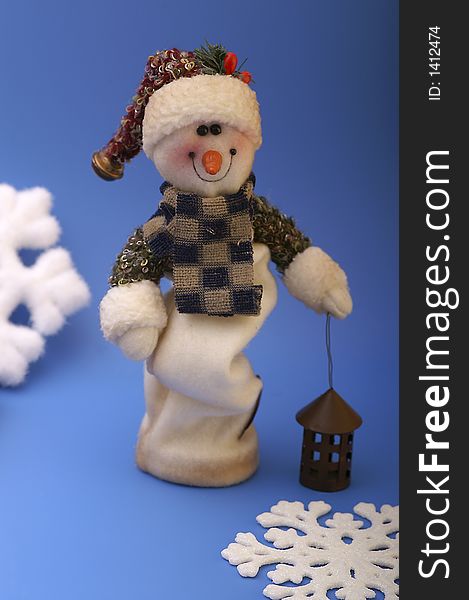Snowman with snowflakes on blue background