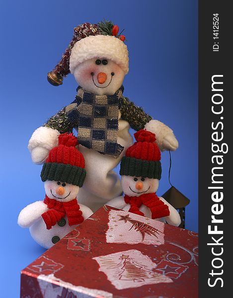Snowmen with christmas gift on blue background