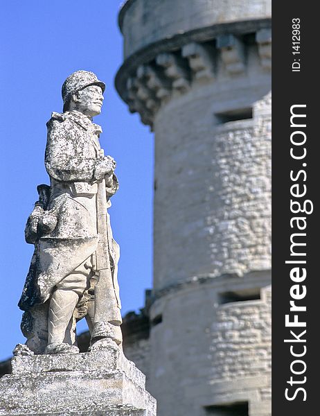 First world wide war statue and a big medieval castle tower as background evoke permanent necessity of defence means in Gordes, a picturesque antique village of Provence, France. First world wide war statue and a big medieval castle tower as background evoke permanent necessity of defence means in Gordes, a picturesque antique village of Provence, France