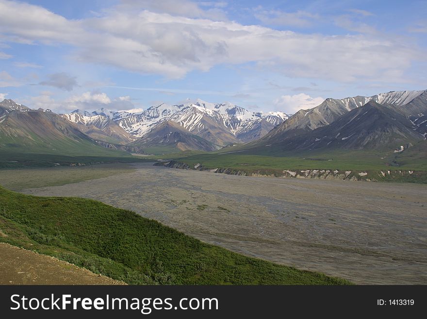 Glacial valley of Denali National Park with mountains in the background. Glacial valley of Denali National Park with mountains in the background