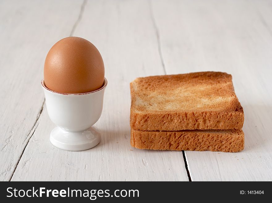 Egg and toasted bread on a table. Egg and toasted bread on a table