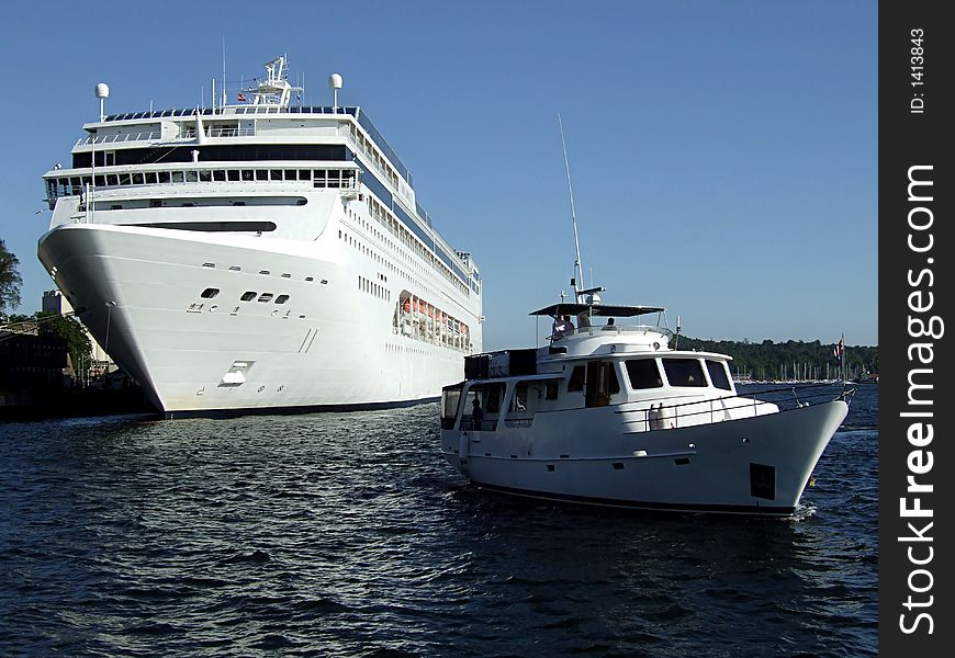 Picture of cruiser and yacht in harbor.