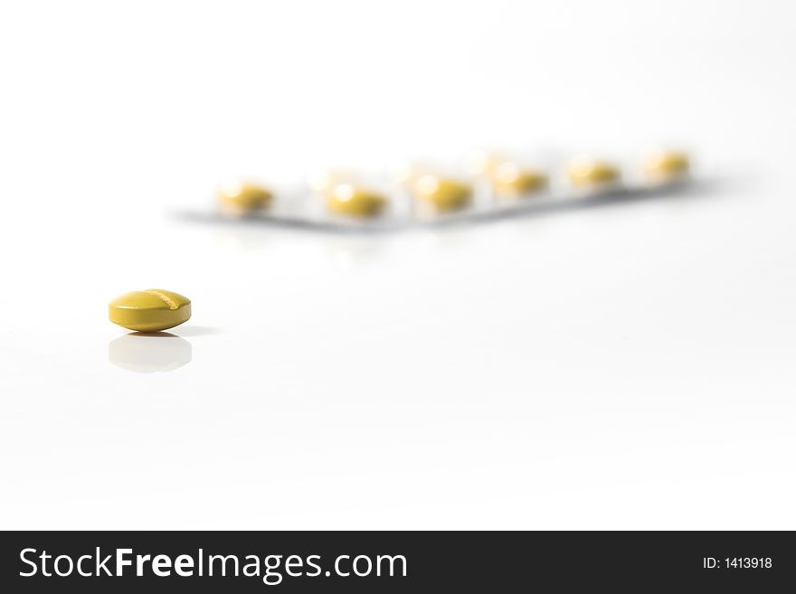 Yellow pill isolated on a white beackground. Yellow pill isolated on a white beackground