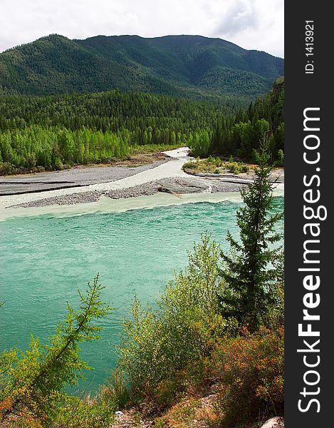 Turquoise River And Mountains.