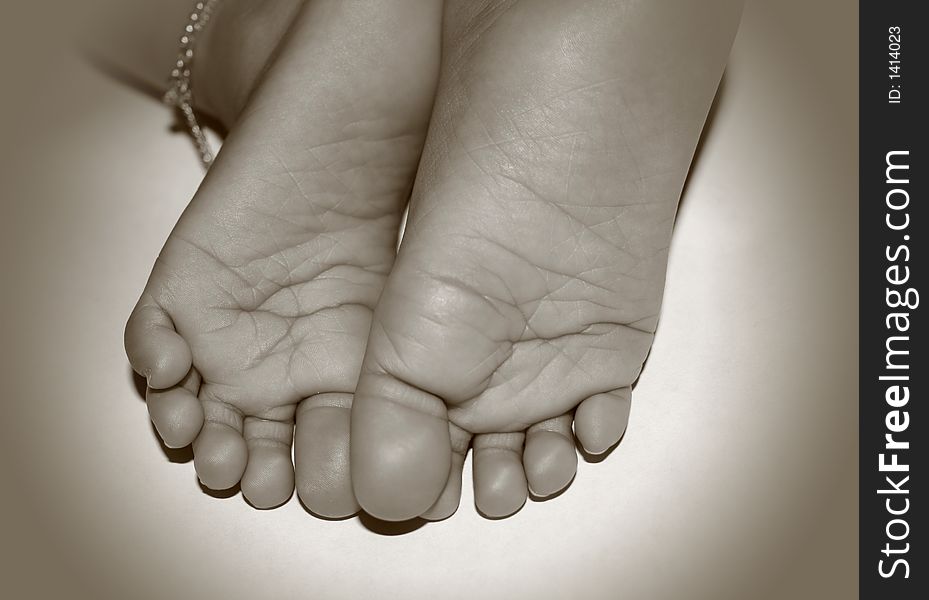 Close up shot of baby feet in sephia