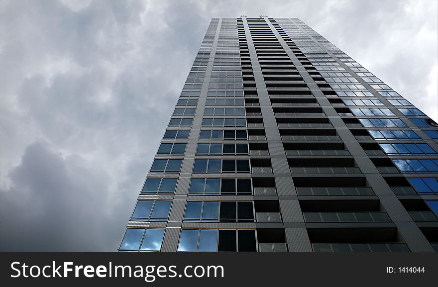 Modern up-stair building and dramatic rainy sky background. Modern up-stair building and dramatic rainy sky background