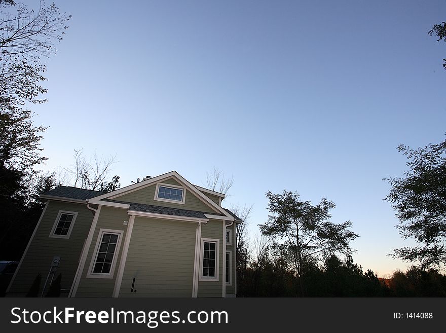 Towering country home/cottage in forest with sky. Towering country home/cottage in forest with sky