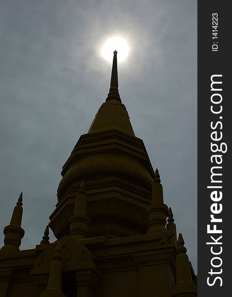 A buddhist stupa is in silhouette at a temple in southern Thailand. A buddhist stupa is in silhouette at a temple in southern Thailand.