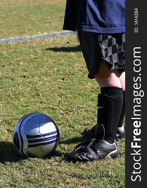 Young boy's legs with soccer cleats, shinguards, and ball. Young boy's legs with soccer cleats, shinguards, and ball