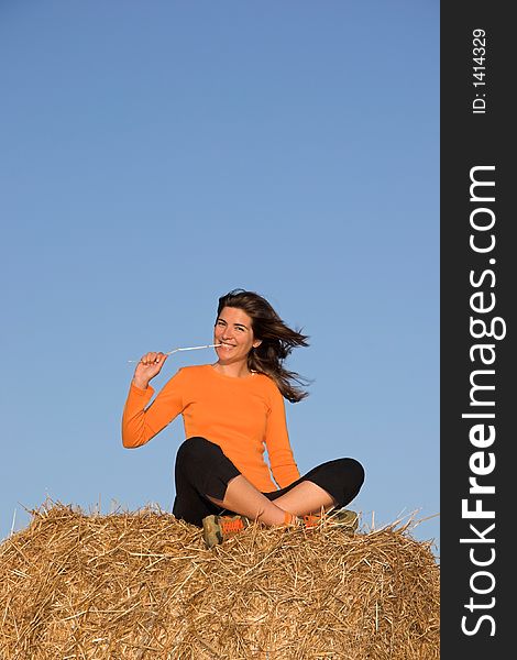 Beautiful woman seated in a field