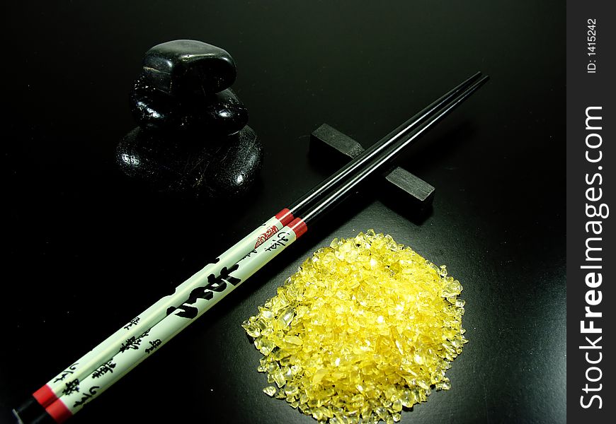 Hot stones and chopstick whit yellow rocks. Hot stones and chopstick whit yellow rocks
