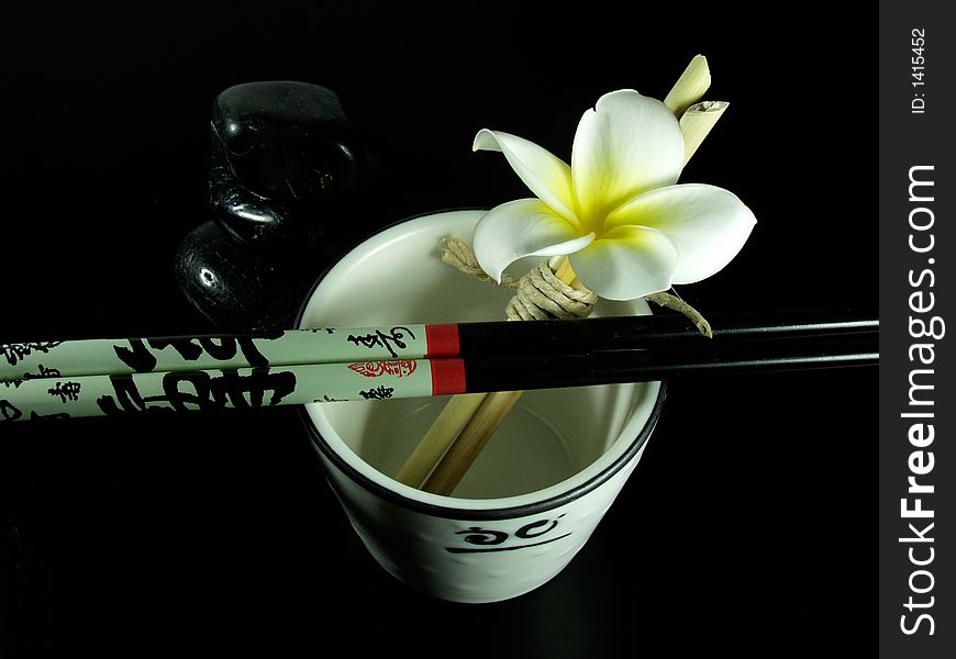 Japanese zen composition whit white flower on tea cup. Japanese zen composition whit white flower on tea cup