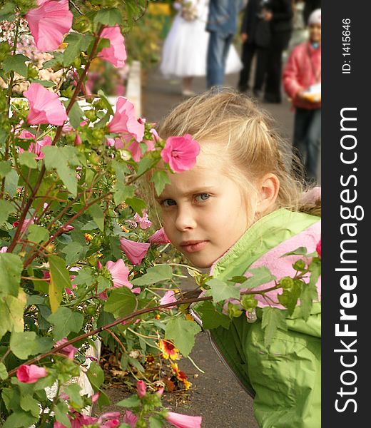 The child and the flowers, portrait, smell, garden. The child and the flowers, portrait, smell, garden