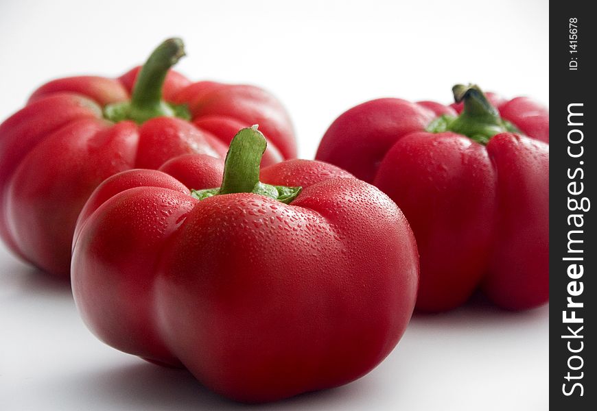 Three fresh red tomato peppers. Three fresh red tomato peppers