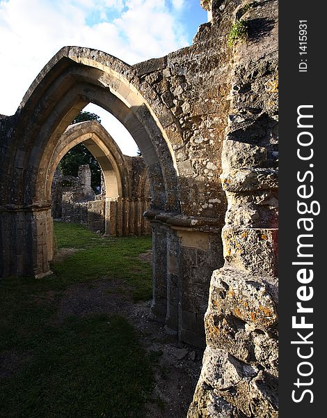 A beautiful ruined but still consecrated church in England under late afternoon sunlight and a blue sky with some clouds. A beautiful ruined but still consecrated church in England under late afternoon sunlight and a blue sky with some clouds