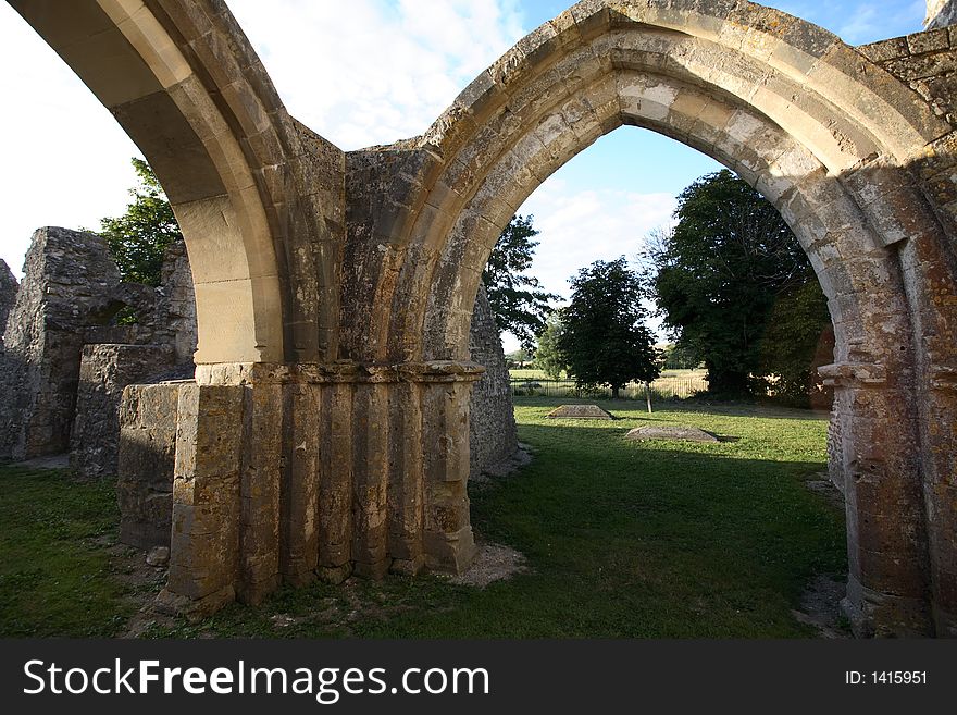 A beautiful ruined but still consecrated church in England under late afternoon sunlight and a blue sky with some clouds. A beautiful ruined but still consecrated church in England under late afternoon sunlight and a blue sky with some clouds