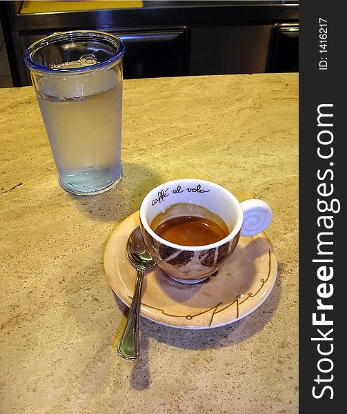 Coffee and a glass of cold water in Italian bar. Coffee and a glass of cold water in Italian bar