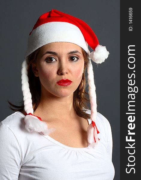 Brunette wearing a santa hat portrait. Brunette wearing a santa hat portrait