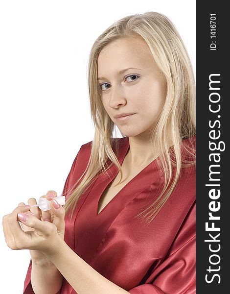 Young woman dressed red bathrobe painting nails (pure white background)