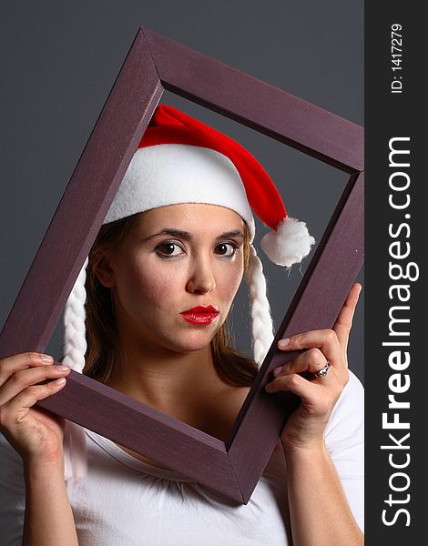 Santa girl within a wooden picture frame. Santa girl within a wooden picture frame