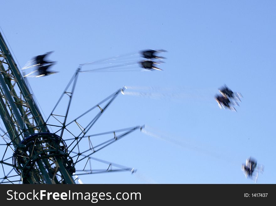 People on a fast merry-go-round; motion-blurred. People on a fast merry-go-round; motion-blurred