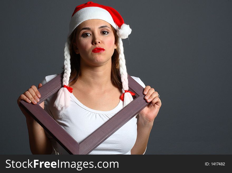 Santa girl within a wooden picture frame. Santa girl within a wooden picture frame