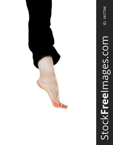Woman leg in black pants over white bg
