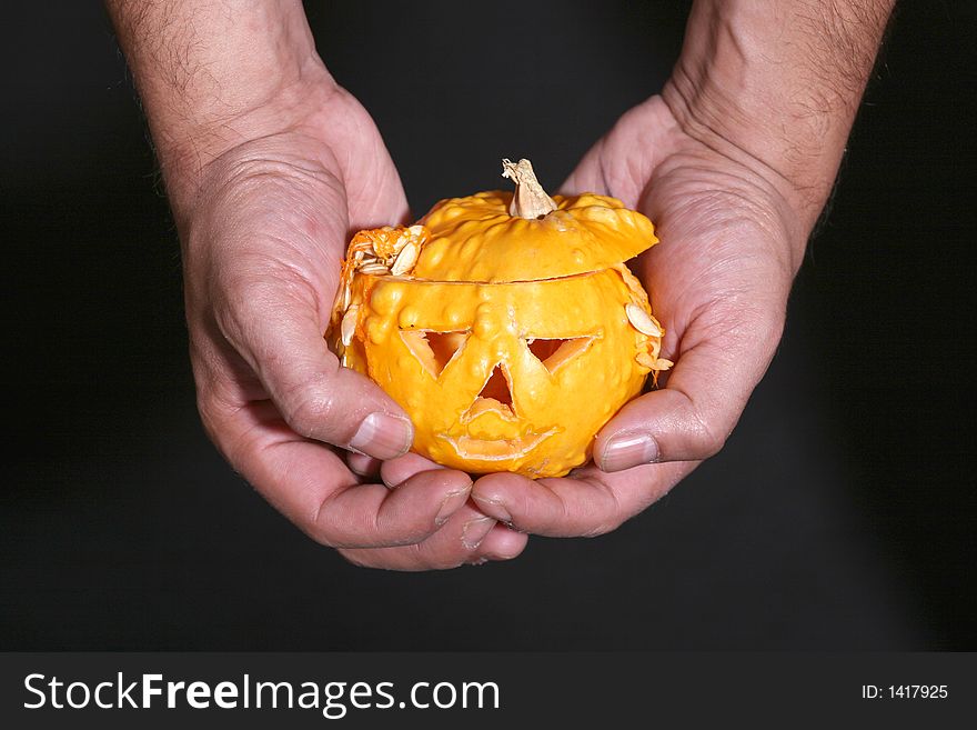 Little halloween pumpkin in the mans hands. Little halloween pumpkin in the mans hands