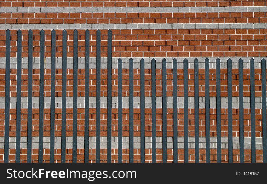 Brick wall with fence, Italy.