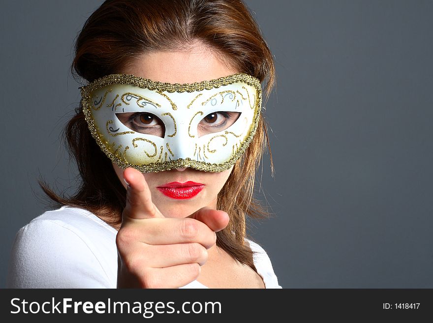 Brunette wearing a mask pointing. Brunette wearing a mask pointing
