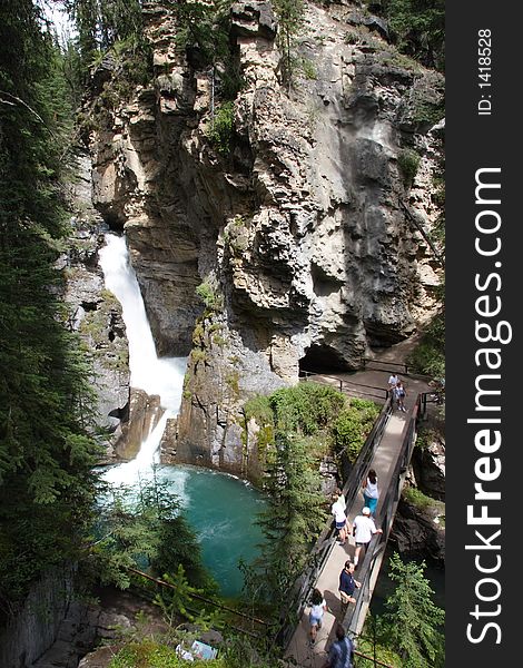 A waterfall in Banff, Alberta, with admiring tourists. A waterfall in Banff, Alberta, with admiring tourists.