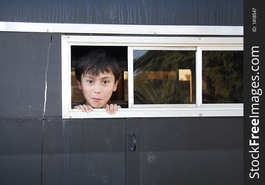 A happy boy in a horse trailer. A happy boy in a horse trailer