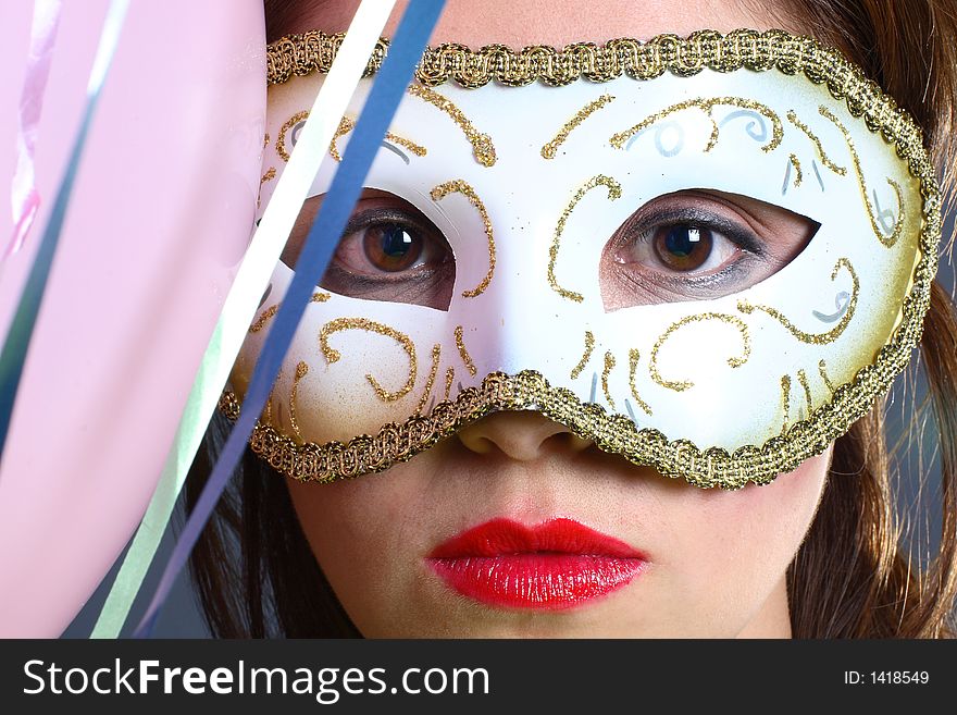 A closeup of brunette wearing a mask. A closeup of brunette wearing a mask