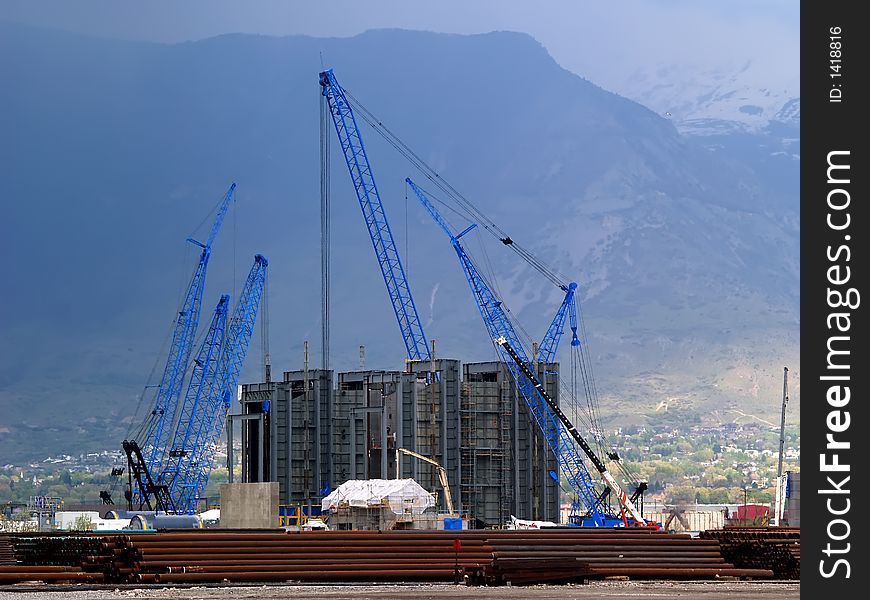Multiple construction cranes at power plant sight. Multiple construction cranes at power plant sight.
