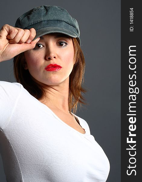 Brunette with grey cap and white shirt. Brunette with grey cap and white shirt