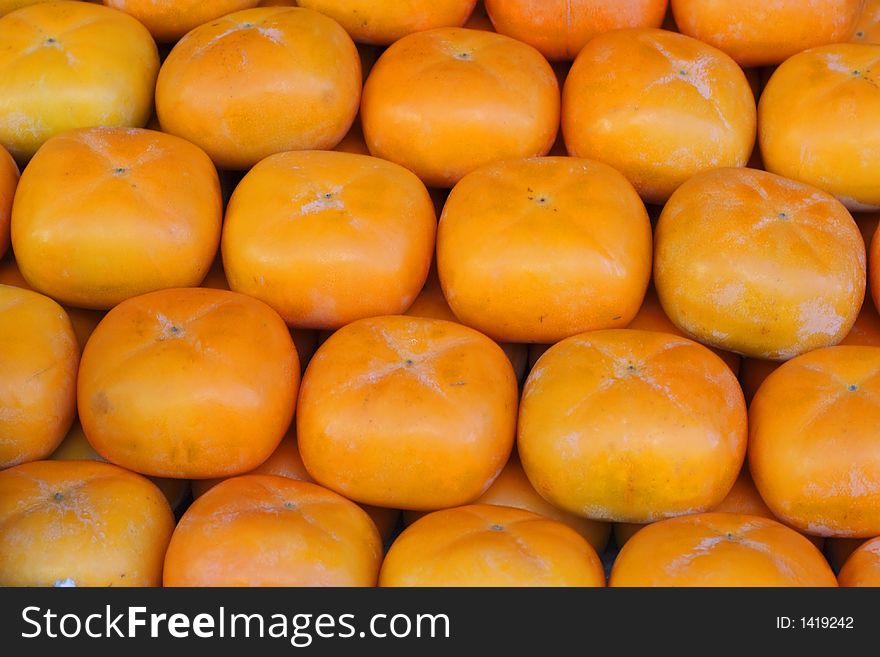 Persimmons fruits on a fruits market stall