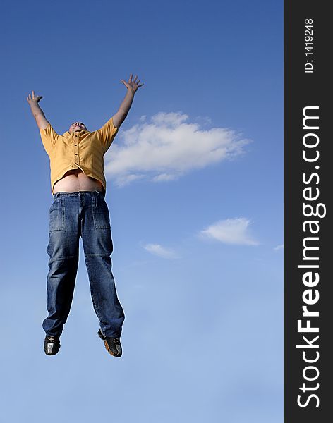 Young boy happily jumping against blue sky. Young boy happily jumping against blue sky.