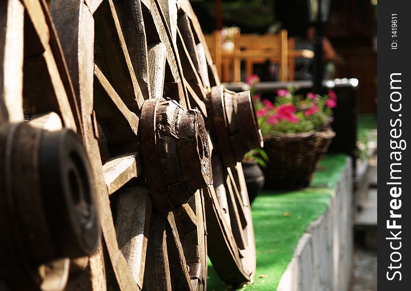 Vintage wooden wheels in cafe entrance. Vintage wooden wheels in cafe entrance