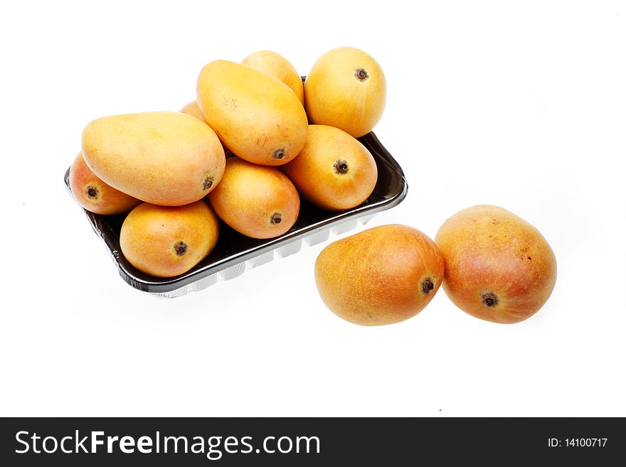 Some fresh mangoes on white.