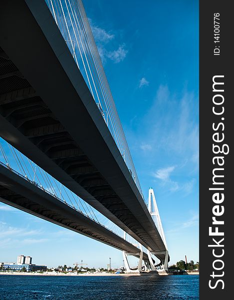 Cable-braced bridge across the river Neva, Russia, St. Petersburg. Blue sky with clouds. Obukhovsky.