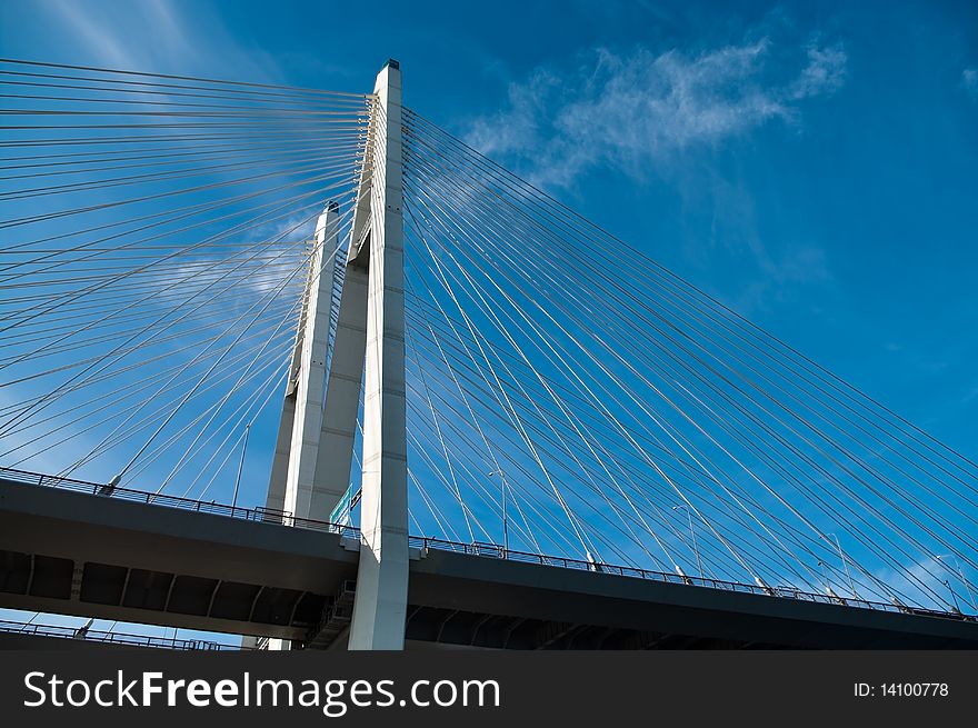 Cable-braced bridge across the river Neva, Russia, St. Petersburg. Blue sky with clouds. Obukhovsky.