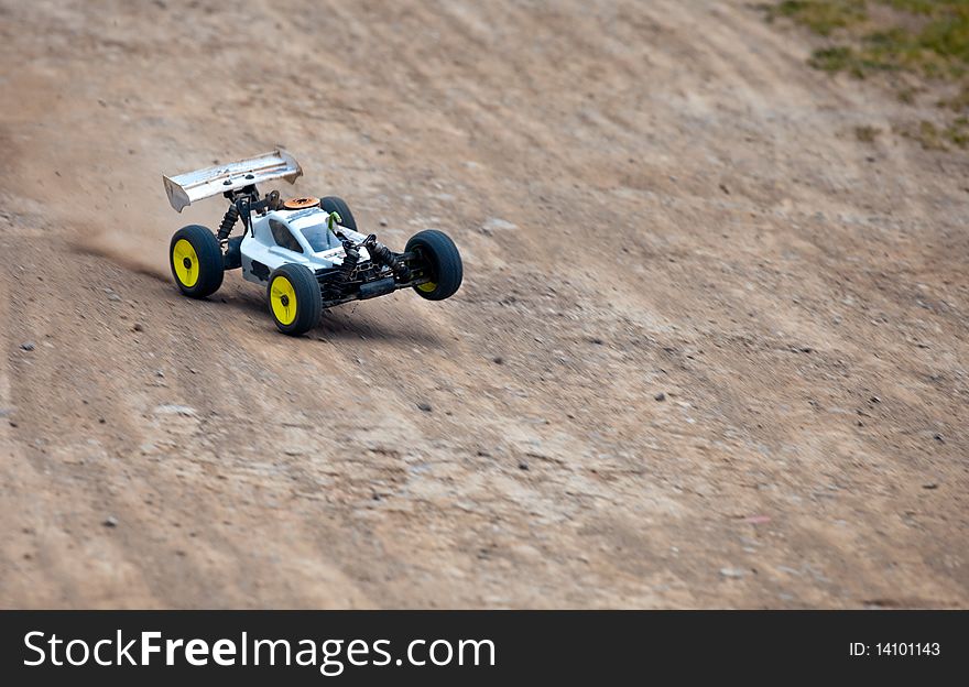 Speeding radio controlled car on the dirt. Speeding radio controlled car on the dirt