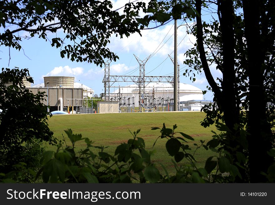 Fuel depot storage tank architecture with a natural green foreground. Fuel depot storage tank architecture with a natural green foreground