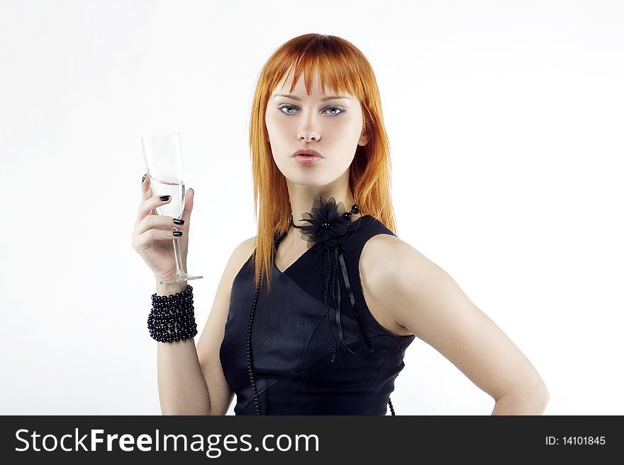 Beautiful red-haired girl lifts a toast, a glass with champagne