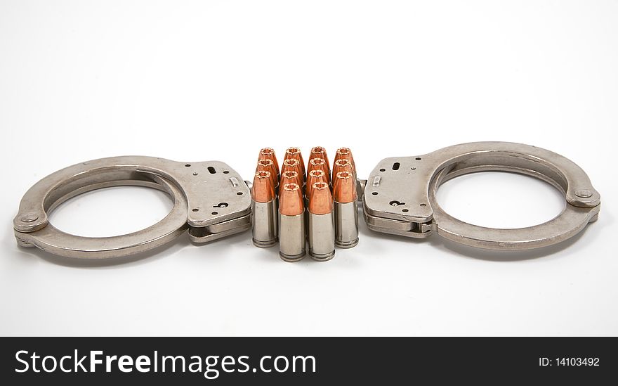 Pair of police handcuffs and 14 9 mm bullets. Pair of police handcuffs and 14 9 mm bullets