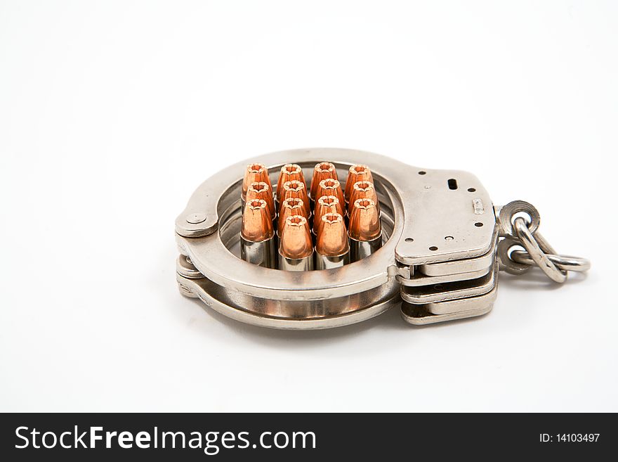 14 9 mm bullets inside a pair of handcuffs. 14 9 mm bullets inside a pair of handcuffs