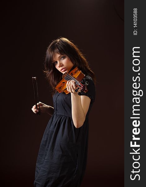 Girl with a violin on a black background. Girl with a violin on a black background