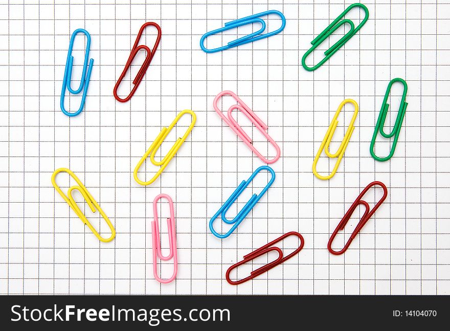 The image of paper clips on notepad page background