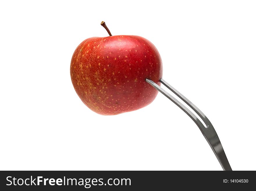 Red apple on the fork on white background